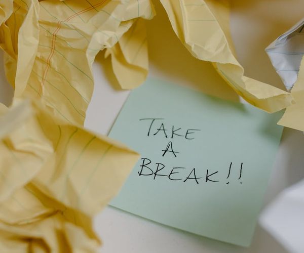 A person taking a brief, mindful pause at their workspace.